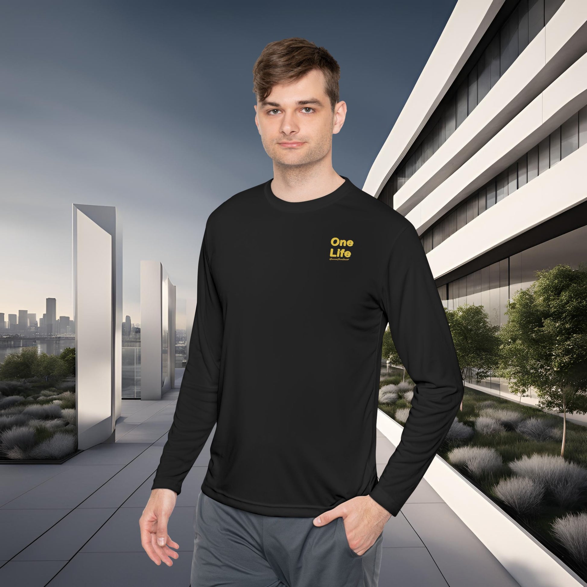 Man wearing a black long-sleeve shirt with 'One Life' text in a modern outdoor setting