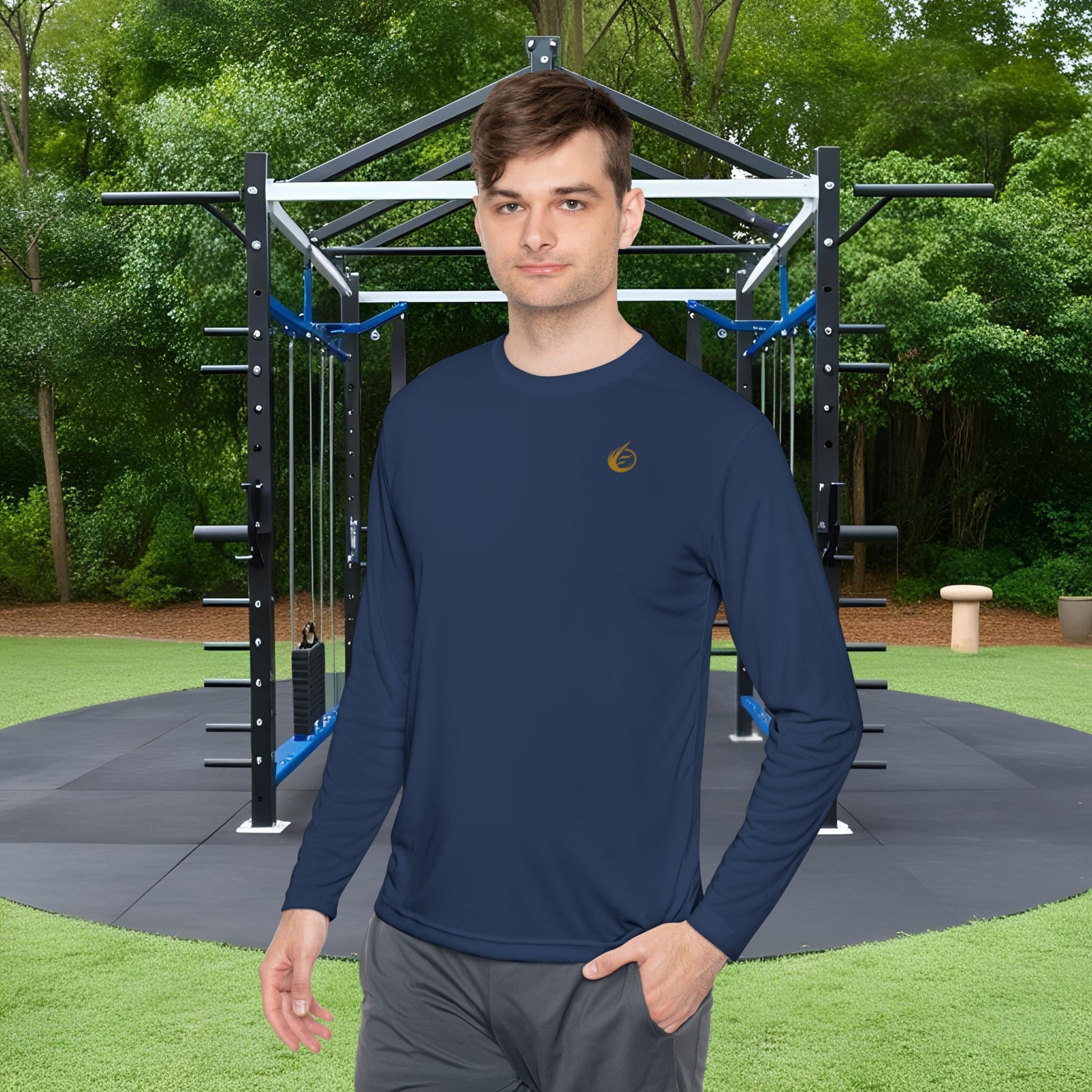 Man wearing a navy blue long-sleeve shirt with 'EssenceInnoCreate' logo in an outdoor fitness area.