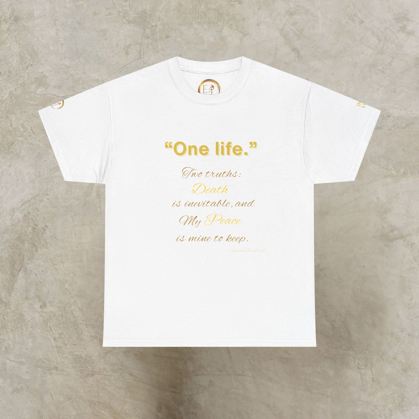 White t-shirt with gold One Life text on a gray concrete background