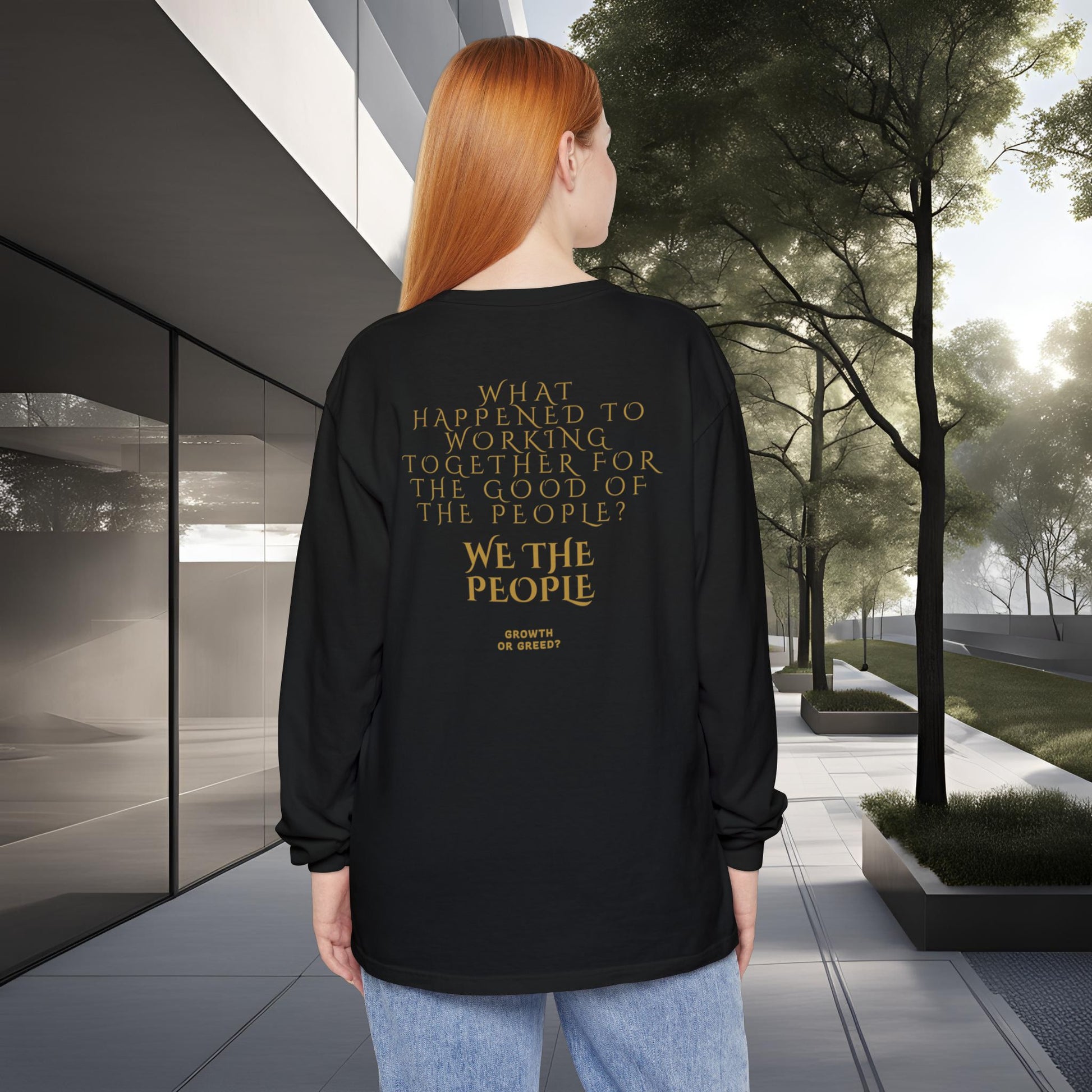 Person wearing a black long-sleeve EssenceInnoCreate Quiet Resolve shirt with text in an urban setting
