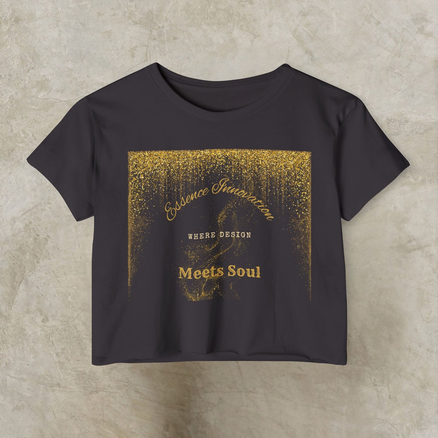 Black t-shirt with gold Essence Innovation 'Design Meets Soul' text and design on a beige background