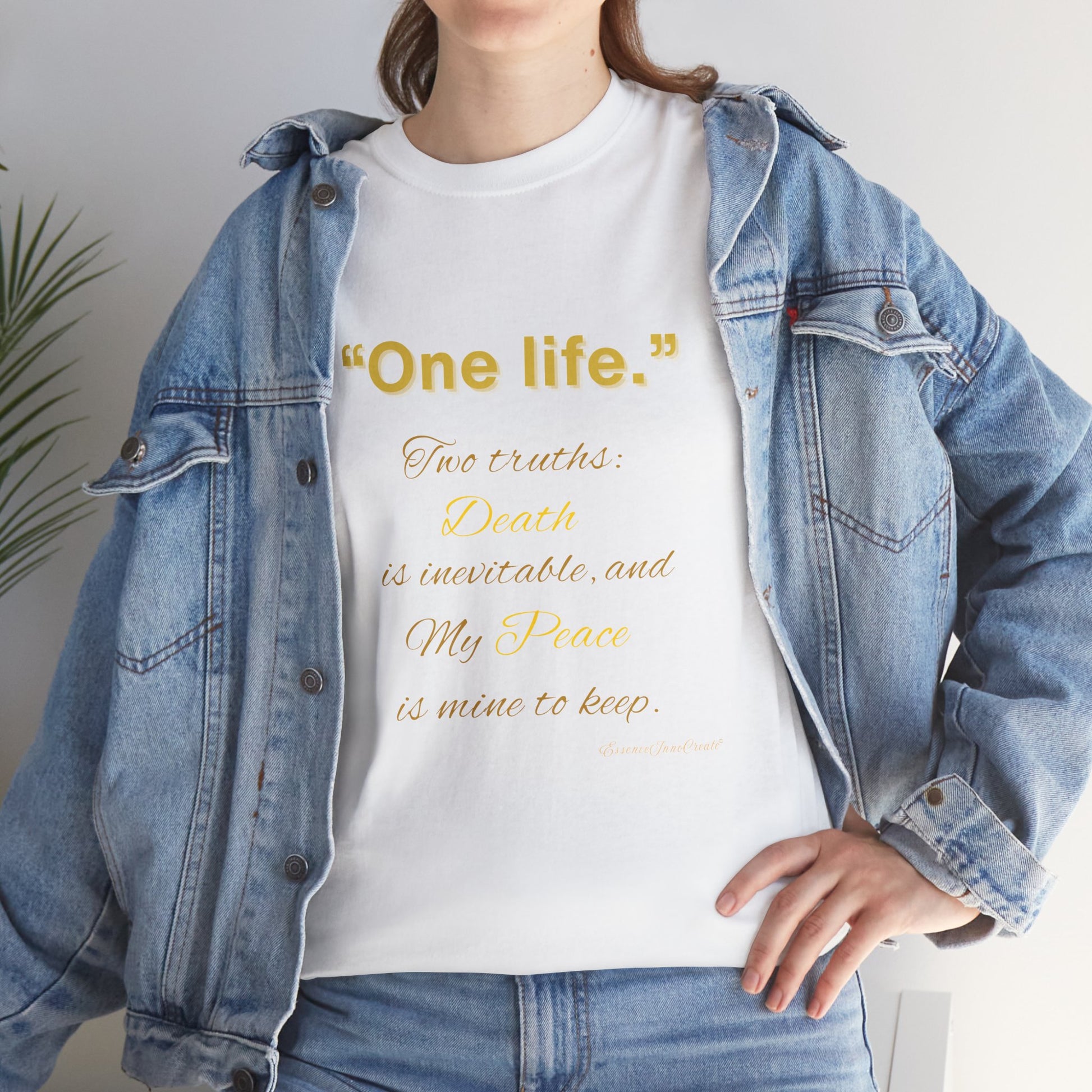 Person wearing a white t-shirt with a One Life quote in yellow text, paired with a denim jacket.