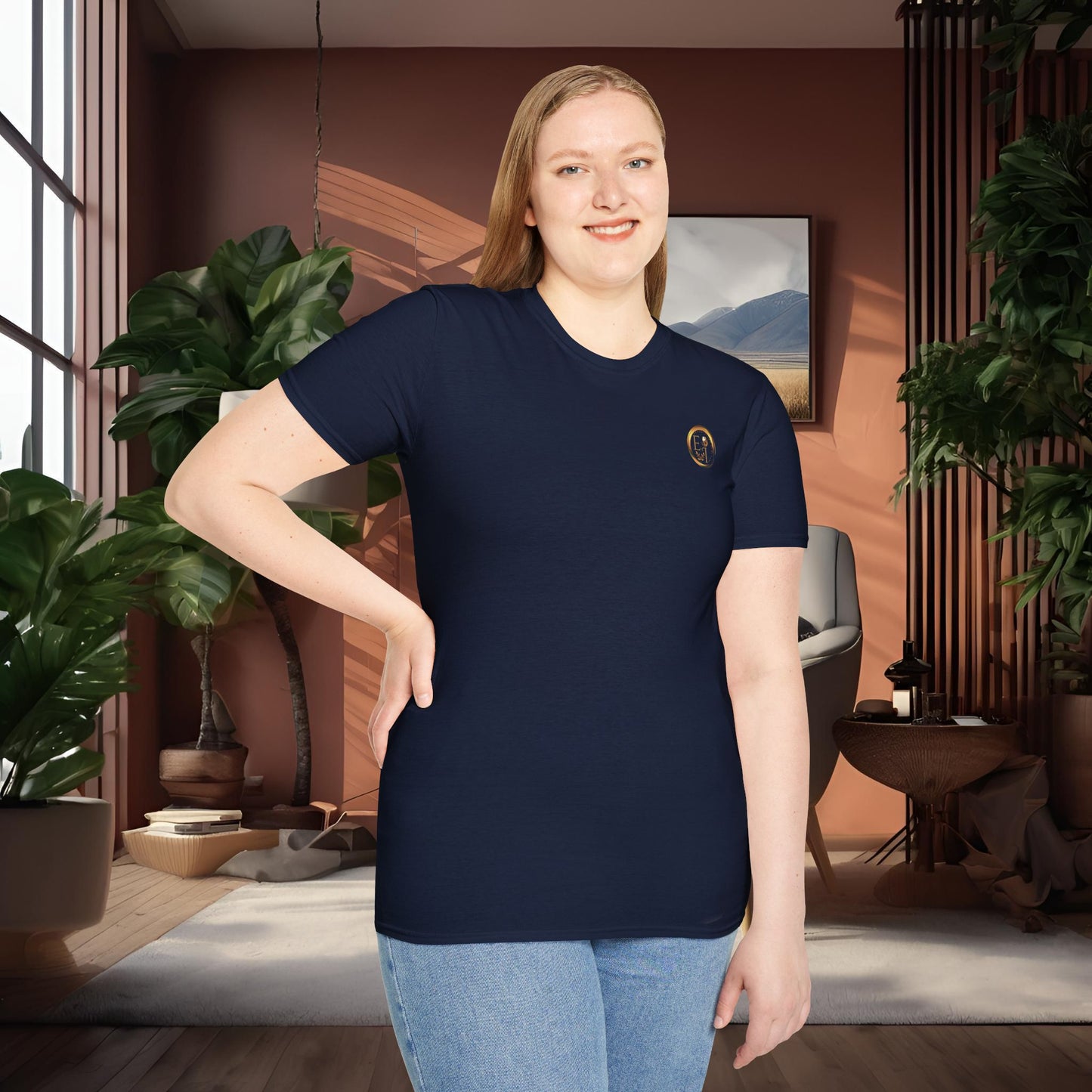 Person wearing a navy t-shirt with an Essence Innovation logo in a room with plants and decor