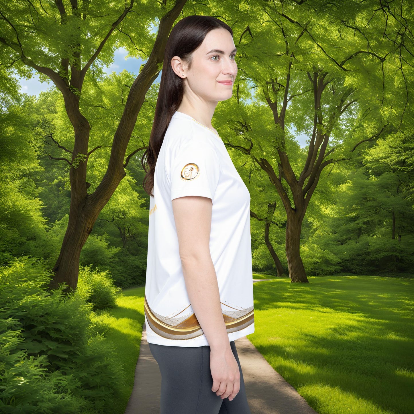 Woman wearing a white t-shirt with a Essence Innovation logo in a park setting
