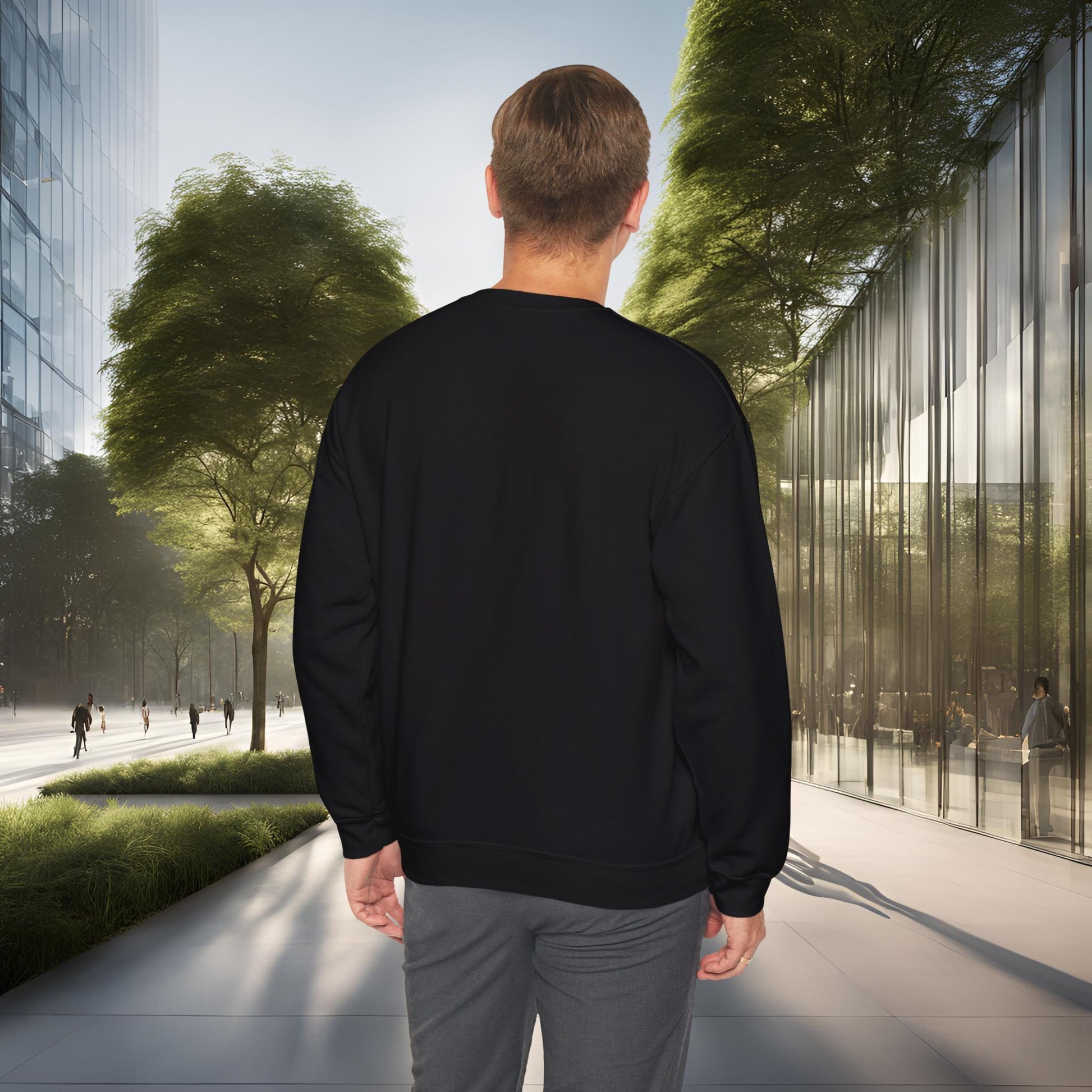 Man wearing a black 'EssenceInnoCreate' sweatshirt walking on a city street with modern buildings and trees.