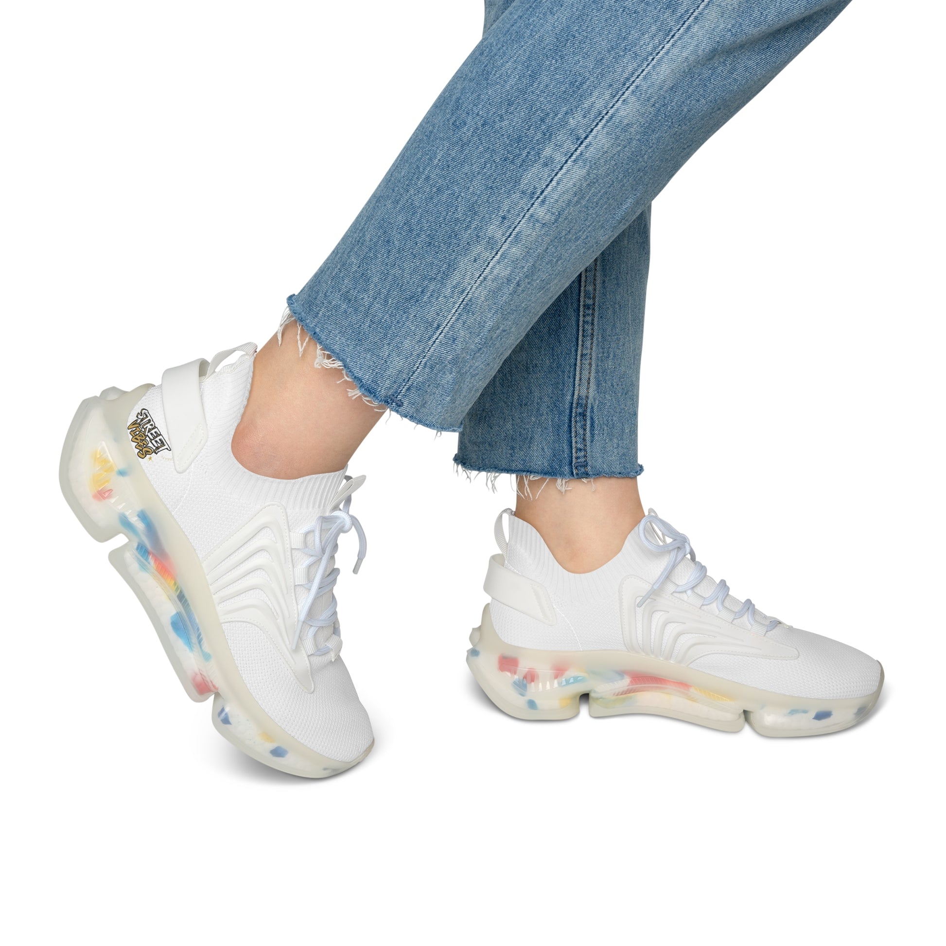 White Essence Innovation 'Street Vibes' sneakers with colorful sole worn with blue jeans on a white background
