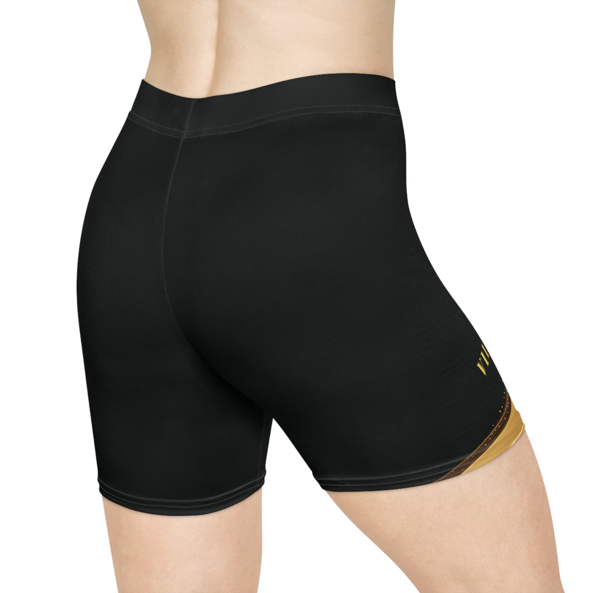 Black athletic shorts with a gold logo on a white background