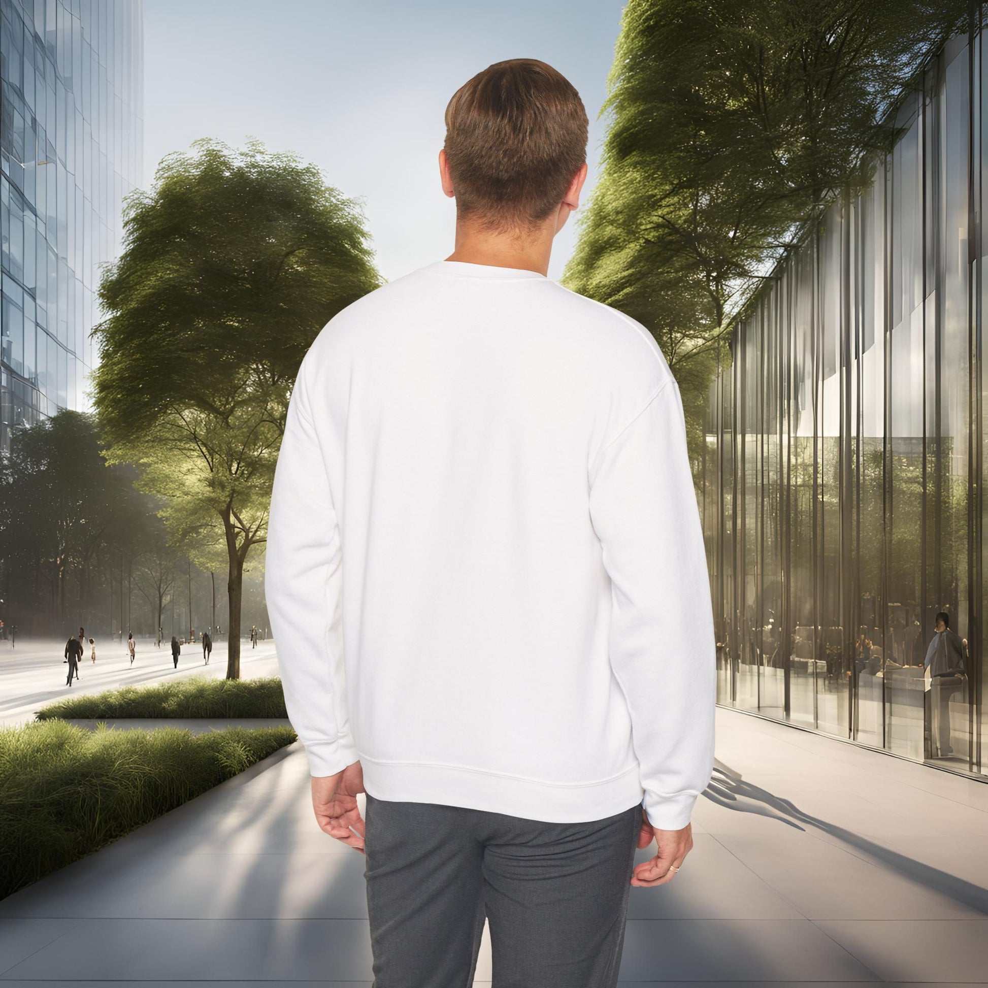 Man in a white 'EssenceInnoCreate' sweatshirt walking on a modern city street with glass buildings and greenery.