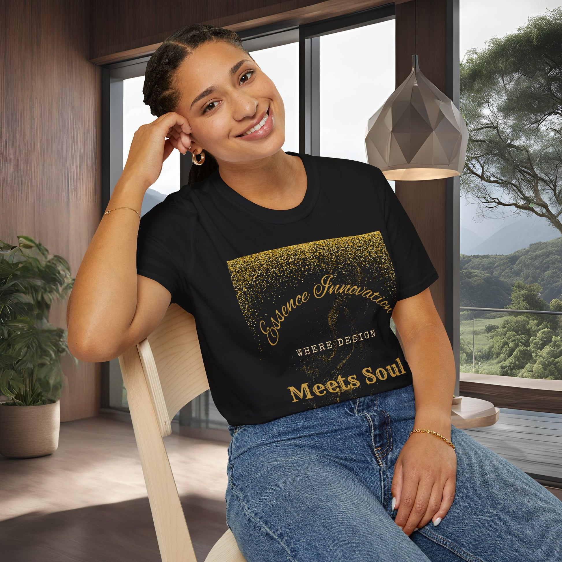 Woman wearing a navy blue t-shirt with gold Essence Innovation 'Design Meets Soul' text in a modern room.