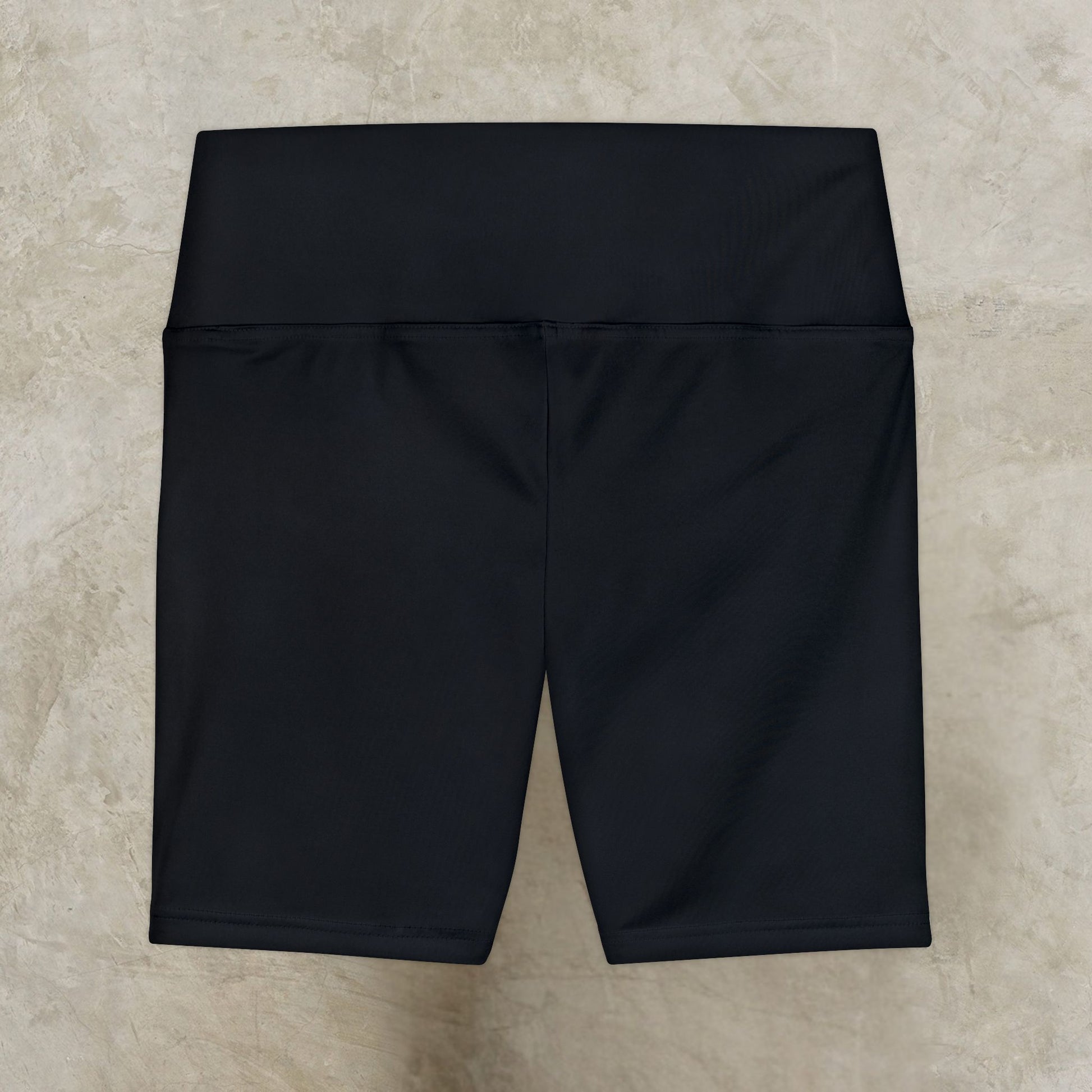 Black shorts on a beige textured background
