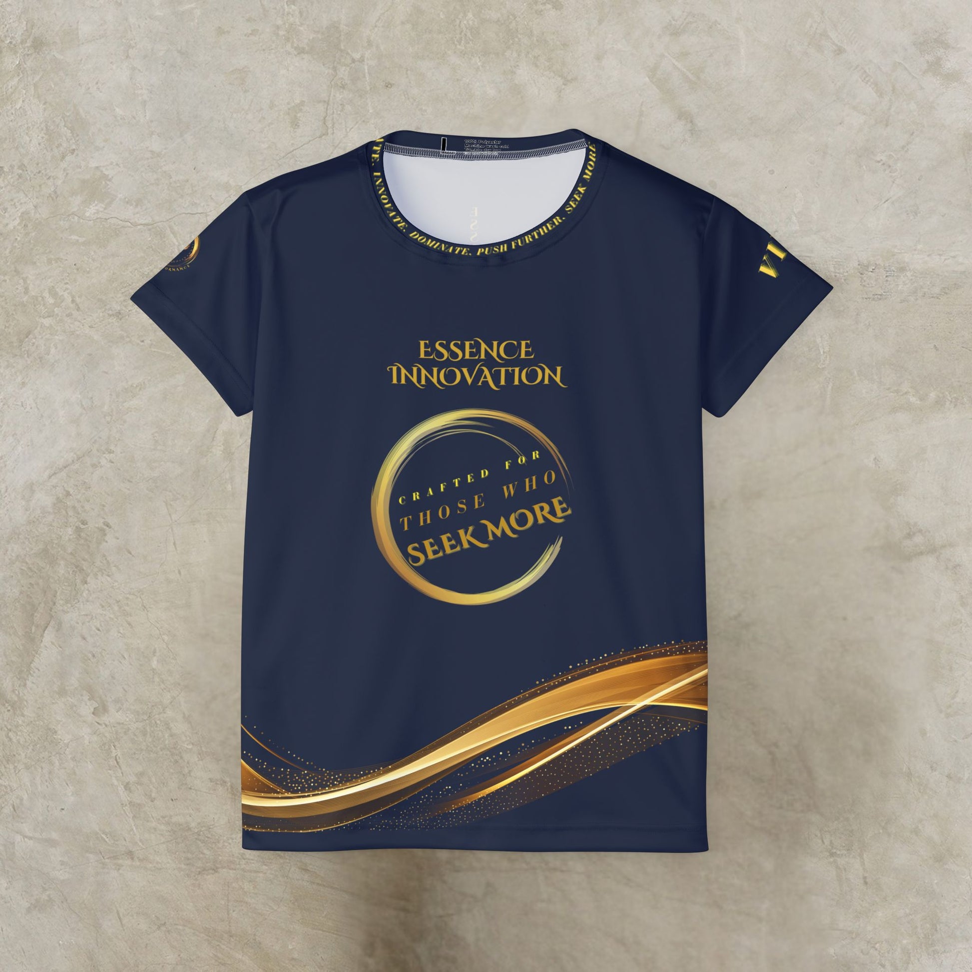 Navy blue t-shirt with gold and white Essence Innovation Seek More text and design on a textured beige background