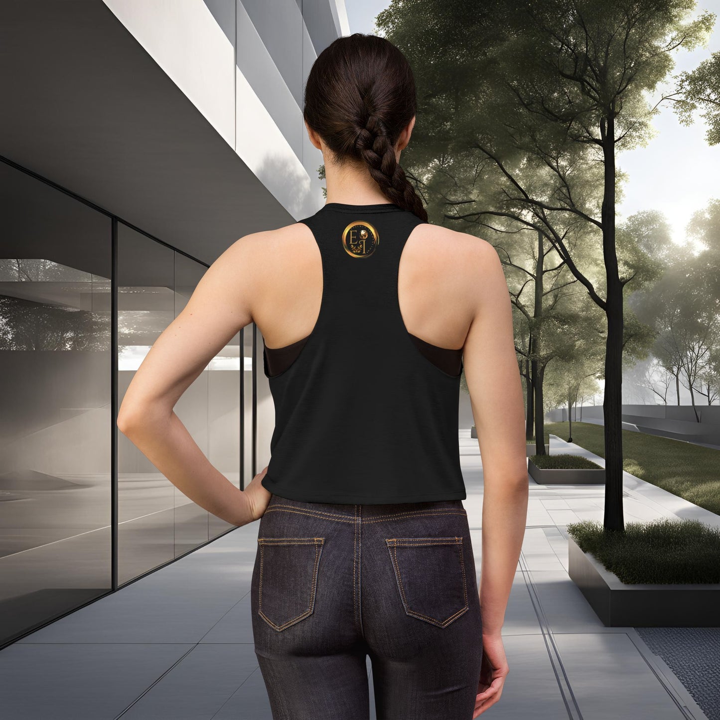 Person wearing a black Essence Innovation Bohemian Butterfly tank top with a logo, standing in an outdoor setting.