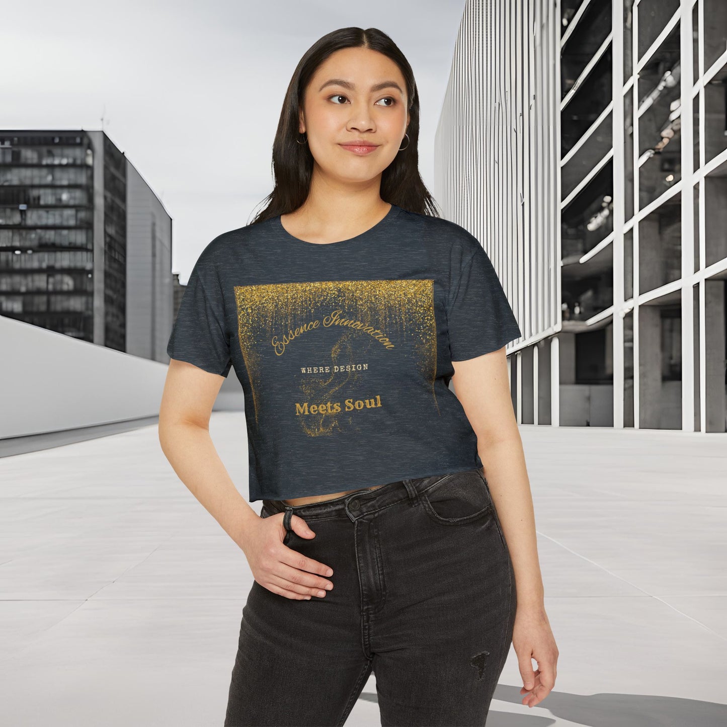 Woman wearing a dark t-shirt with gold Essence Innovation 'Design Meets Soul' text in an urban setting