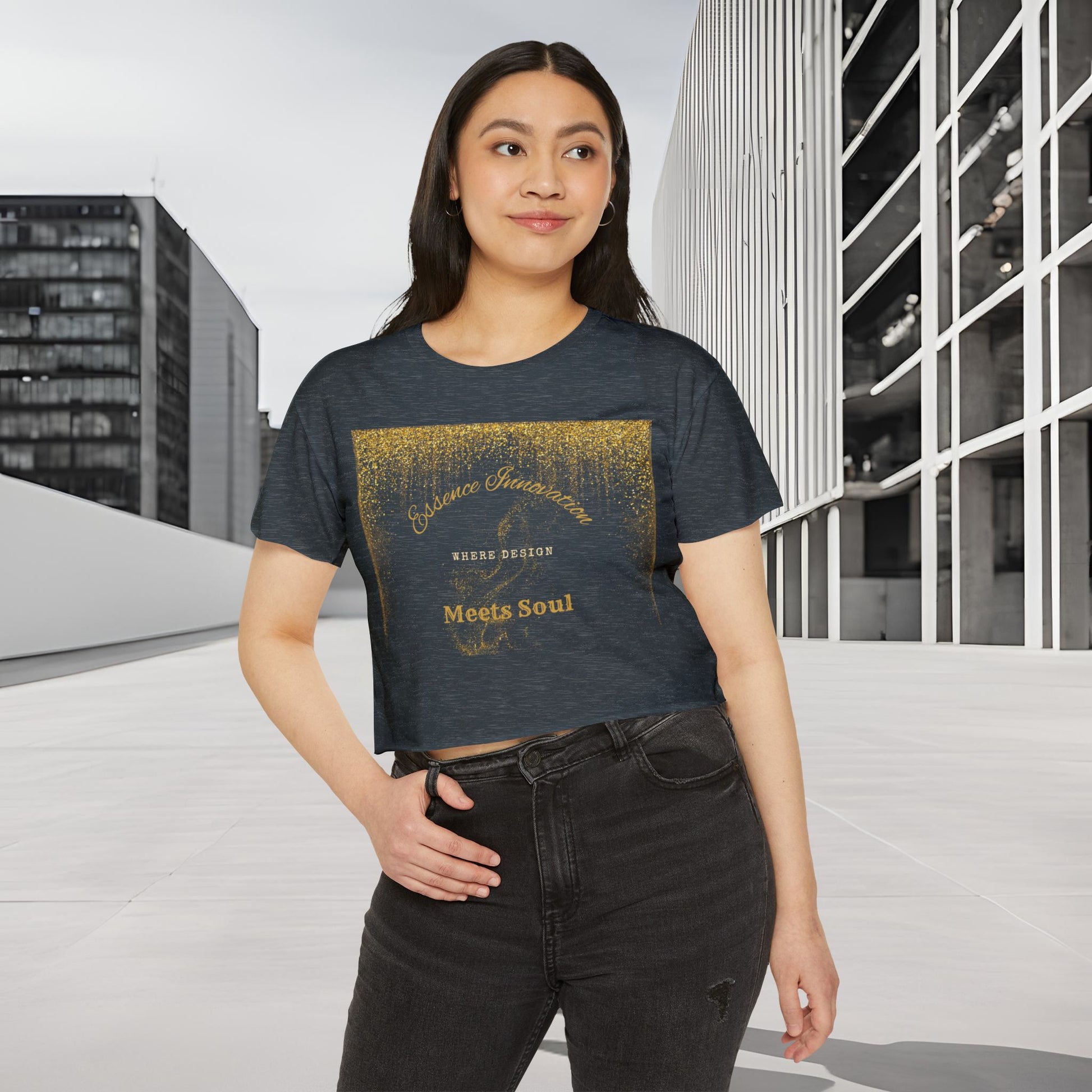 Woman wearing a dark t-shirt with gold Essence Innovation 'Design Meets Soul' text in an urban setting