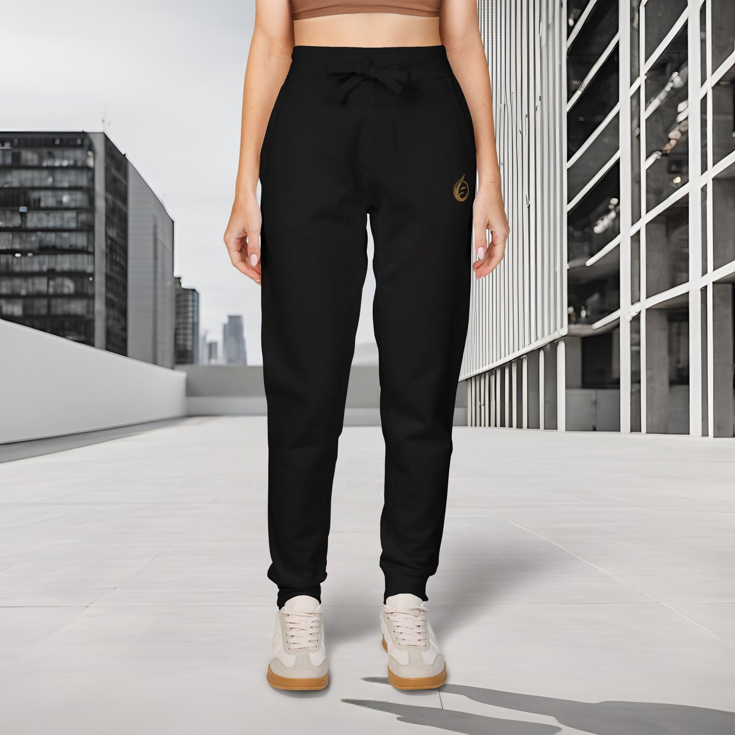 Person wearing black 'EssenceInnoCreate' Quiet Resolve jogger pants with a logo in an urban setting