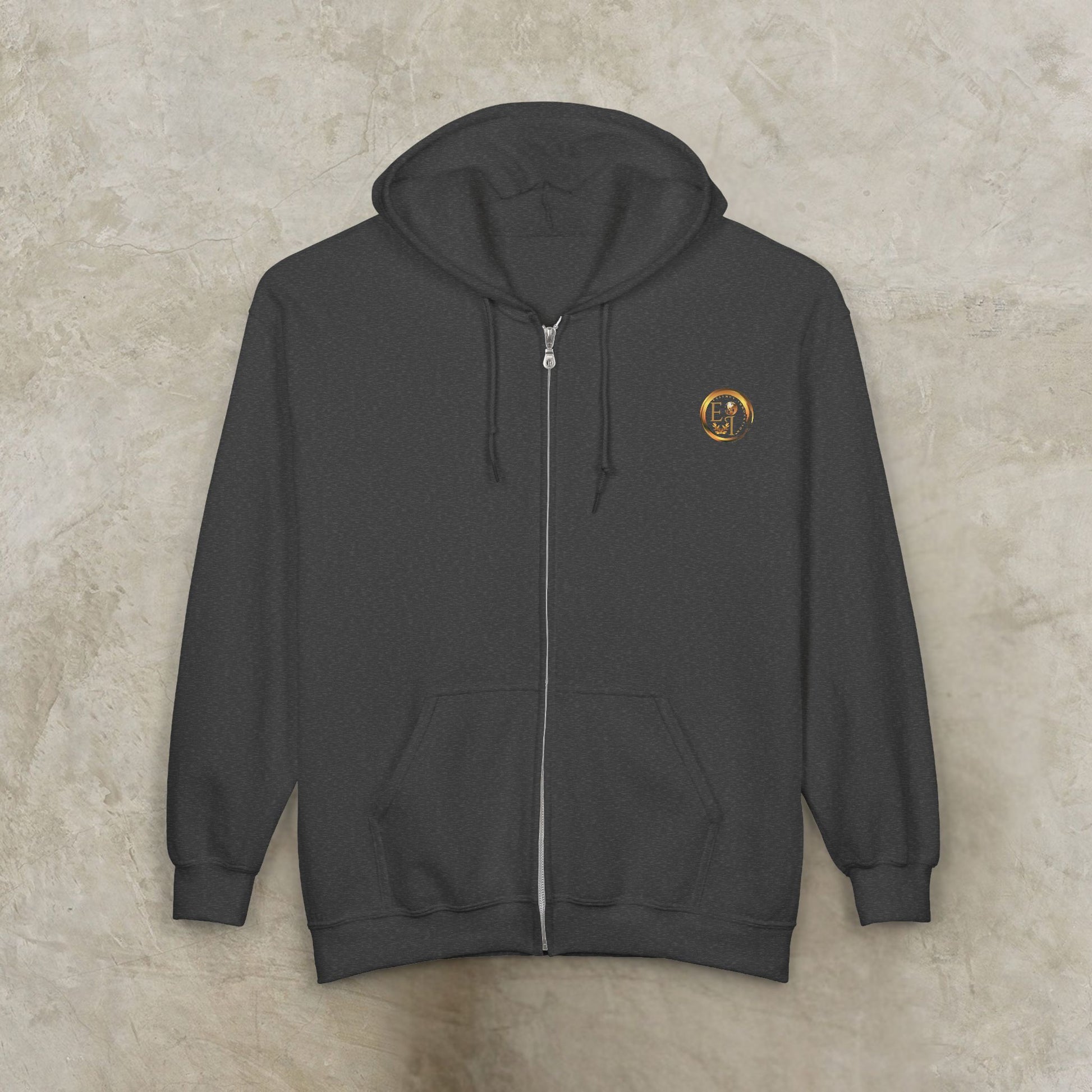 Dark gray Essence Innovation 'One Life' hoodie with a small logo on the chest against a beige background