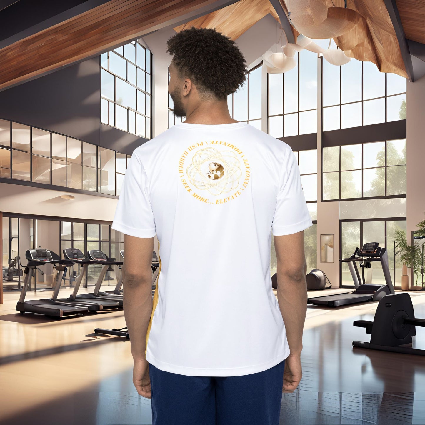 Man wearing a white t-shirt with a Essence Innovation Seek More logo in a gym setting