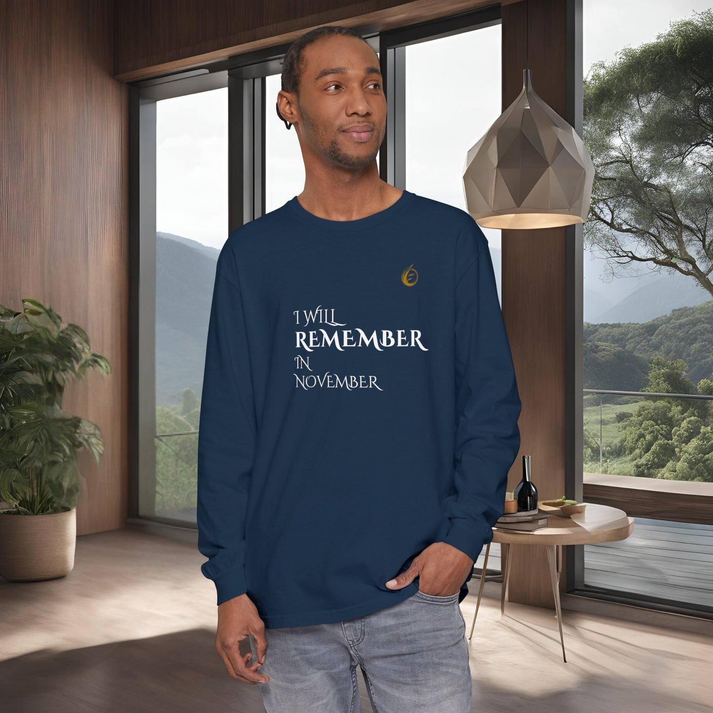 Man wearing a navy blue long-sleeve EssenceInnoCreate Quiet Resolve shirt with text in a modern room with large windows.