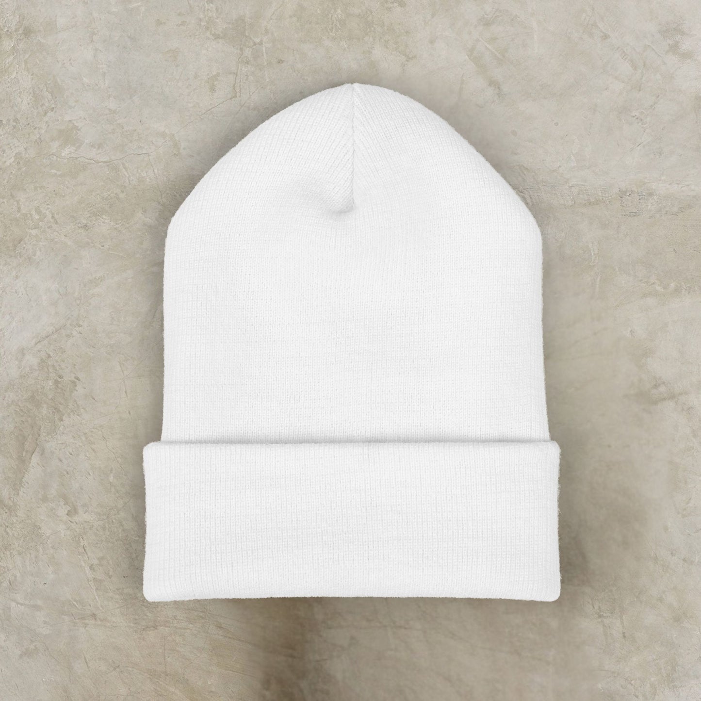 White EssenceInnoCreate beanie on a beige marble background