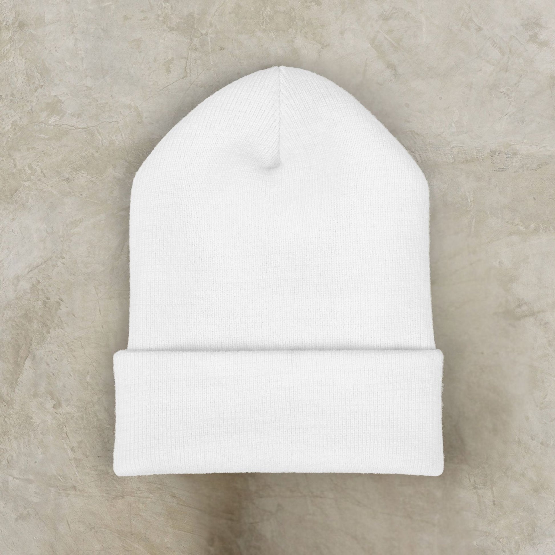 White EssenceInnoCreate beanie on a beige marble background