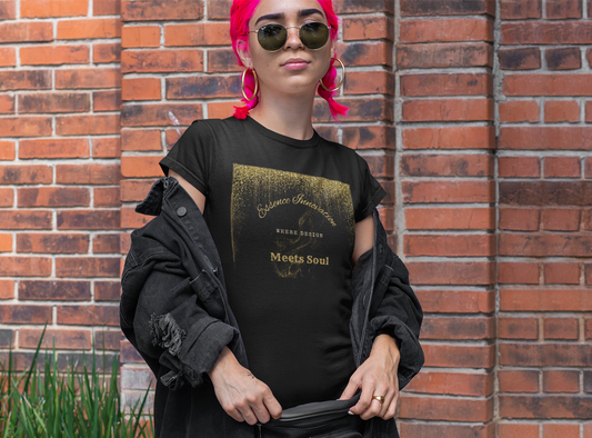 Black t-shirt with gold graphic Essence Innovation 'Design Meets Soul' design on a textured beige background