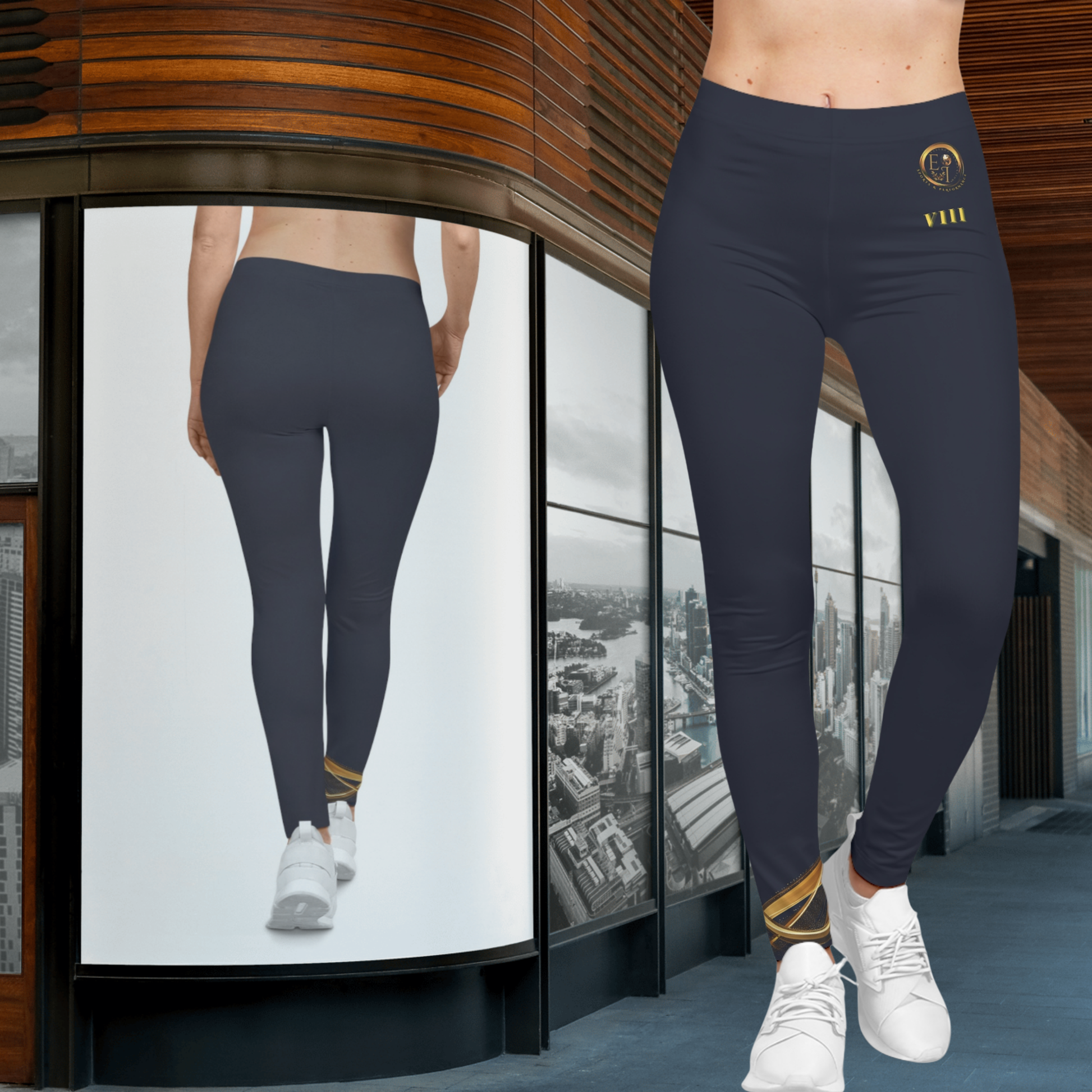 Person wearing dark blue Essence Innovation leggings with a logo, standing in front of a glass wall with cityscape view.
