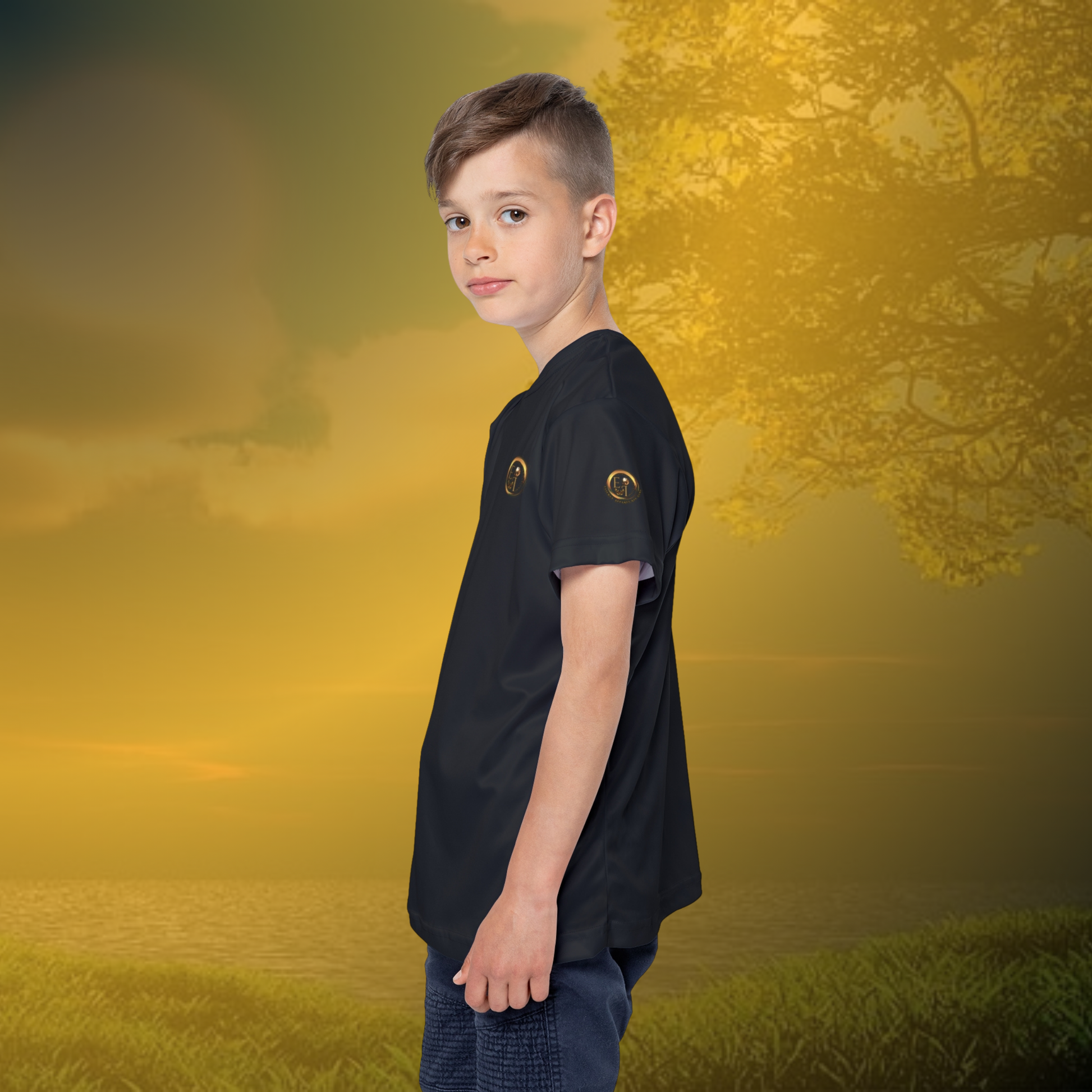 Child wearing a black Essence Innovation t-shirt with a logo on a golden sunset background