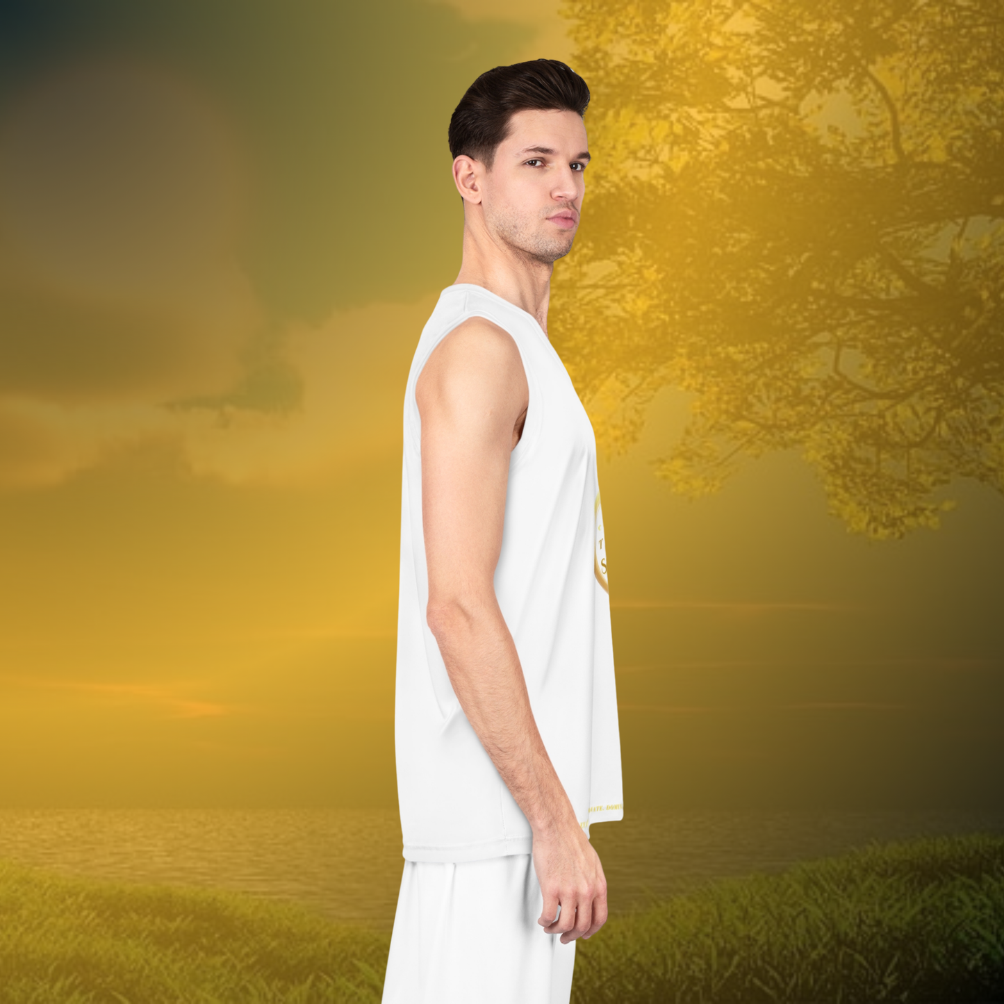 Man in a white tank top and pants standing in a field with a blurred background