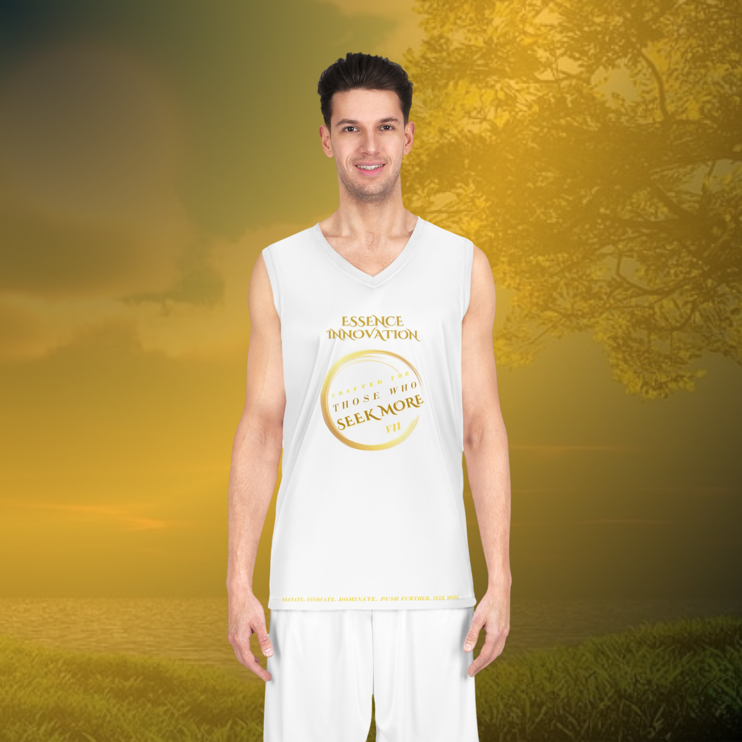Man wearing a white sleeveless shirt with a logo and text, standing in a scenic outdoor setting.