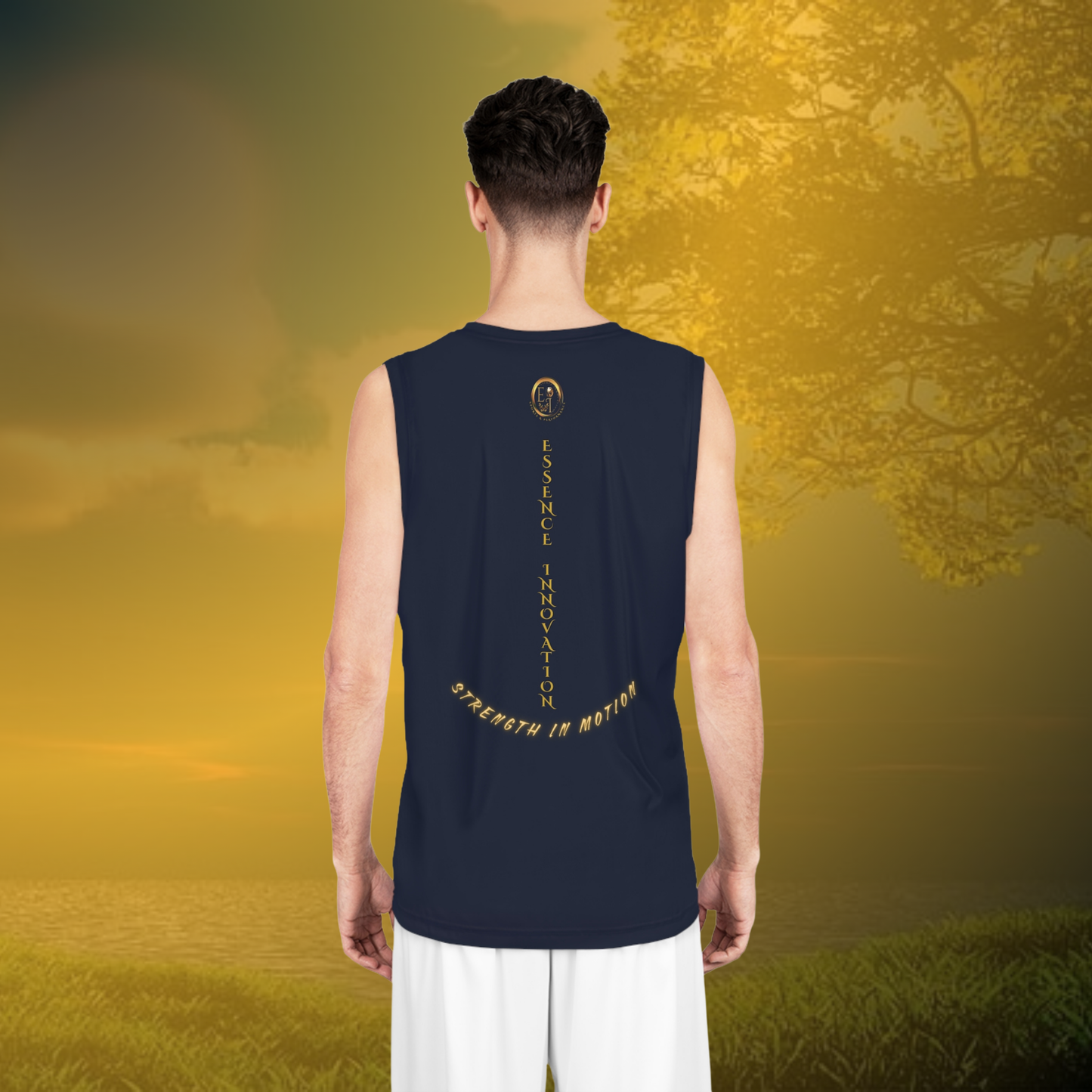Person wearing a Navy sleeveless shirt with text standing in a field with trees and sunset.