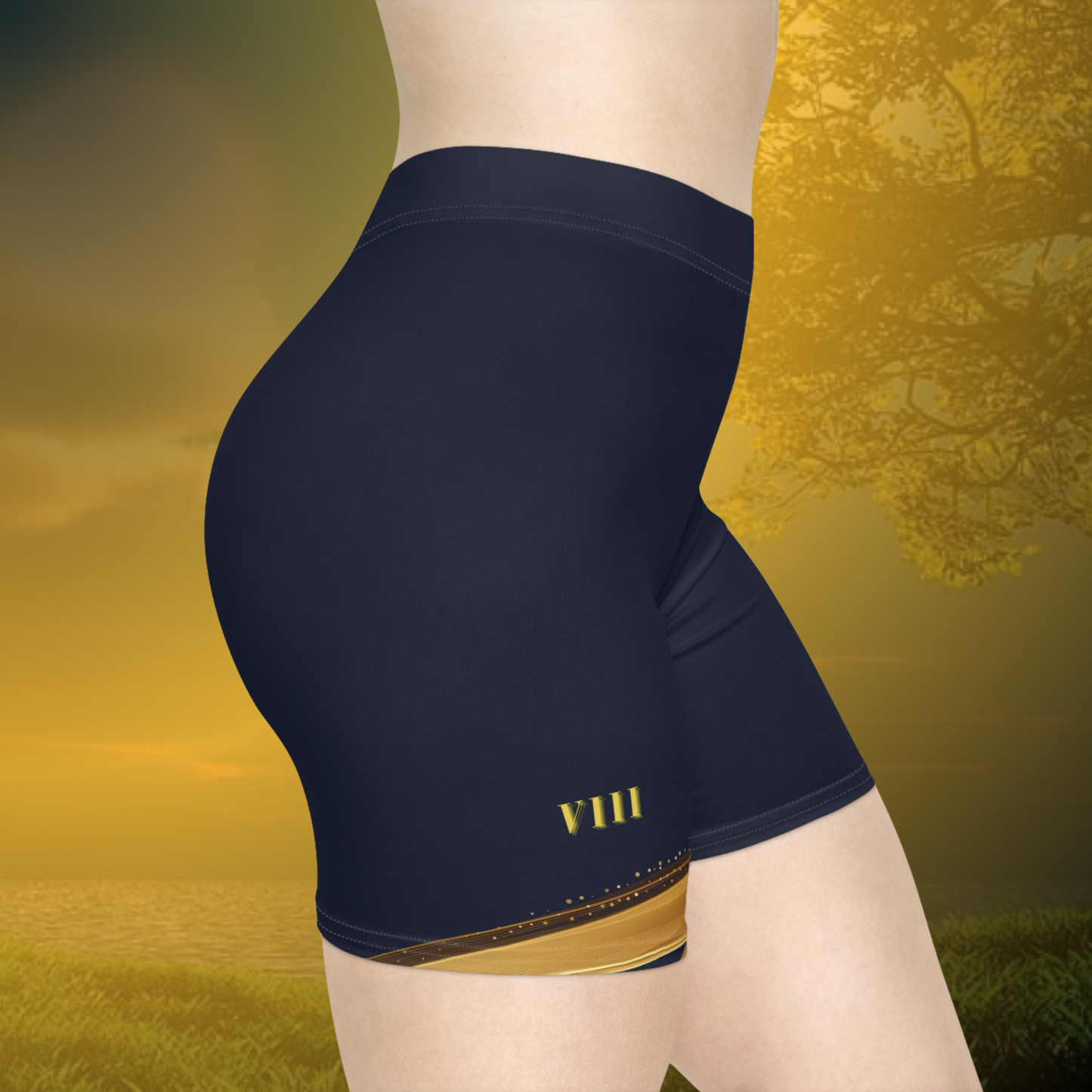 Essence Innovation Navy blue athletic shorts with gold accents on a scenic background