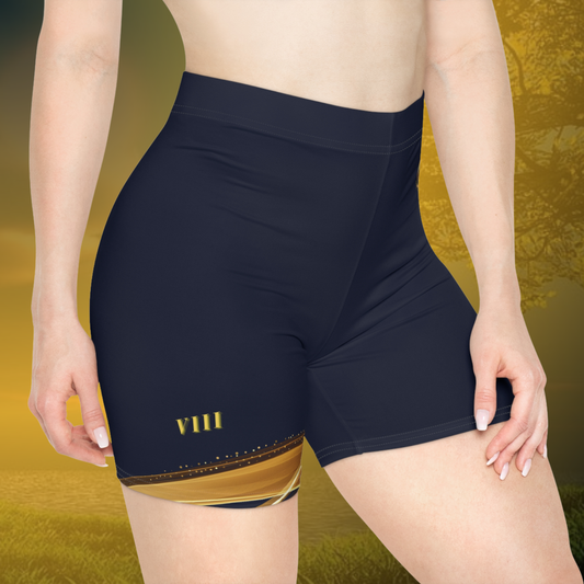 Person wearing navy blue Essence Innovation swim shorts with gold accents on a yellow background