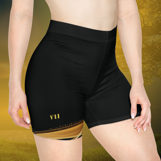 Black Essence Innovation athletic shorts with gold accents on a yellow background